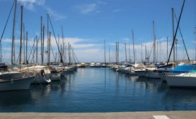 The private boats parked in the port under the pure blue sky