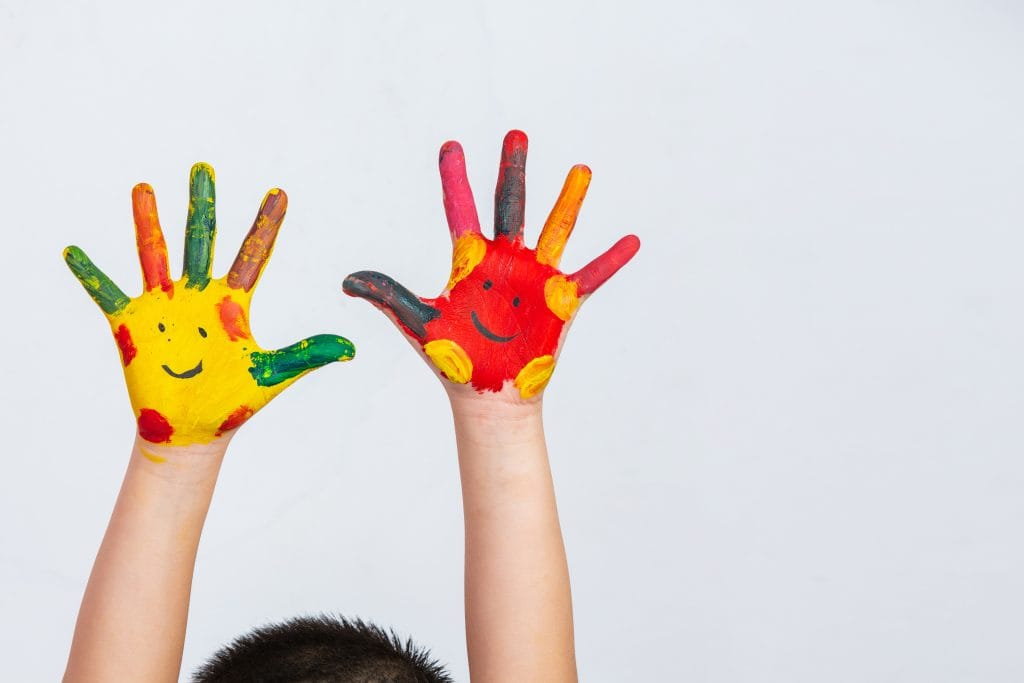 The hands of the child who smeared on the gray background.